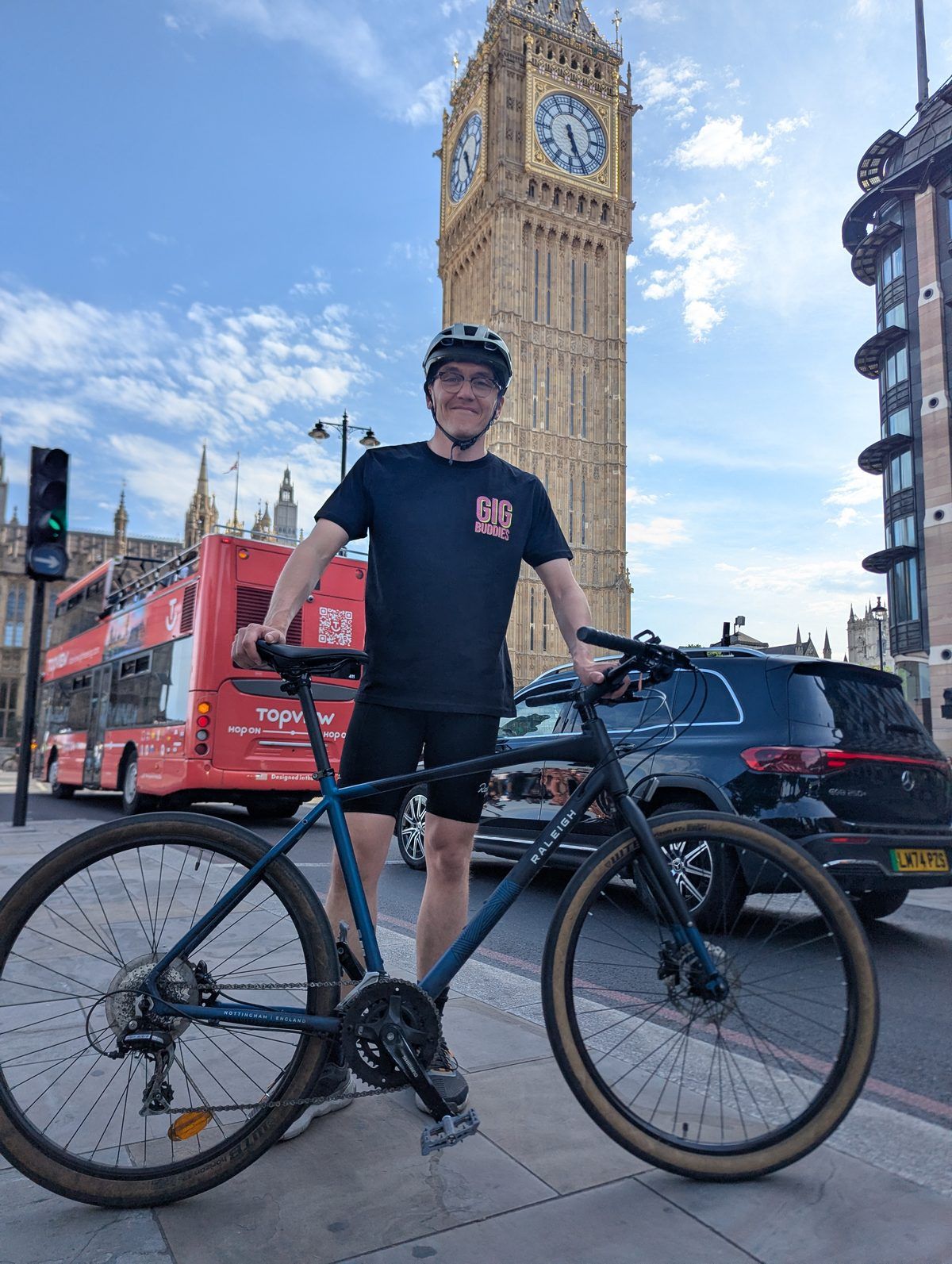 Callum Kroon wearing a Gig Buddies t-shirt in front of Big Ben