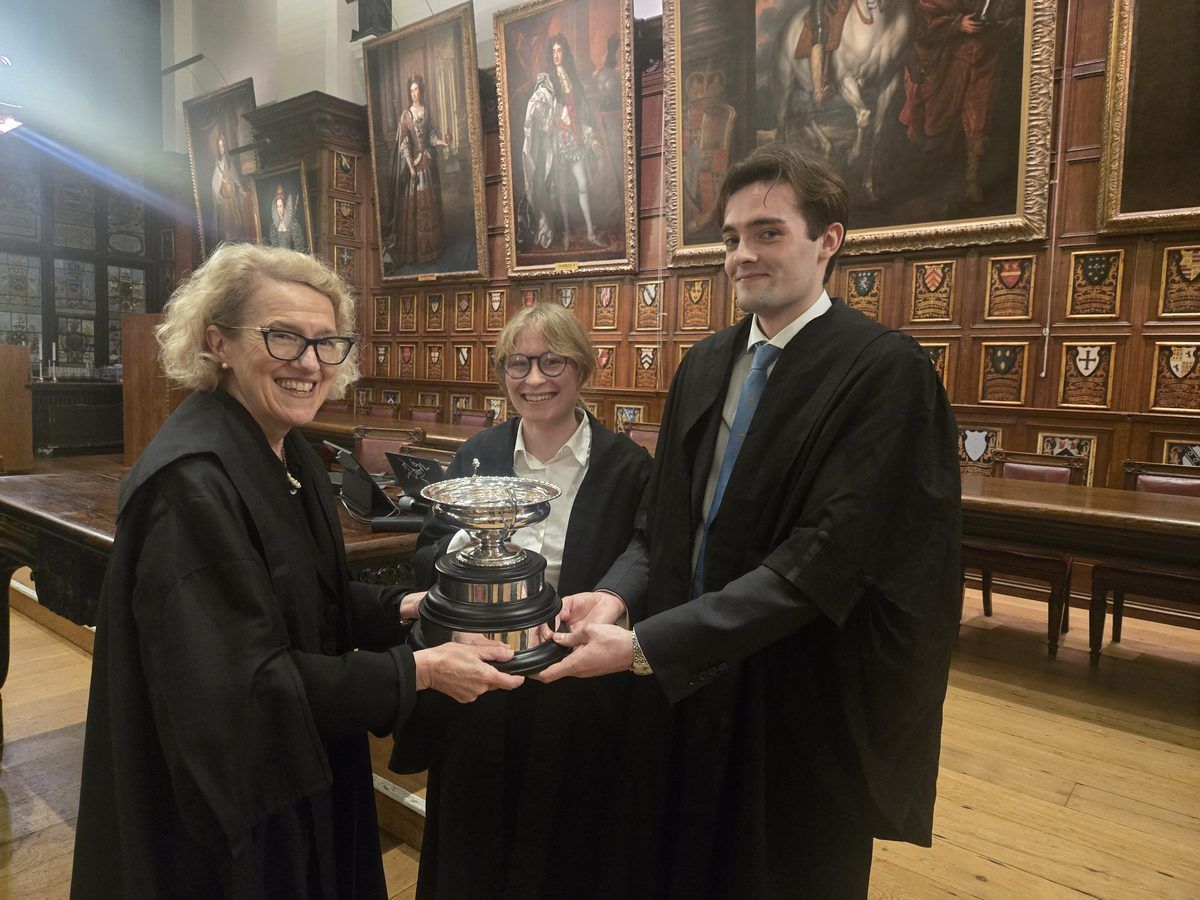 William Sanders and Kate Tidmarsh receive the Rosamund Smith Mooting Competition cup from Master Kate Thirlwall