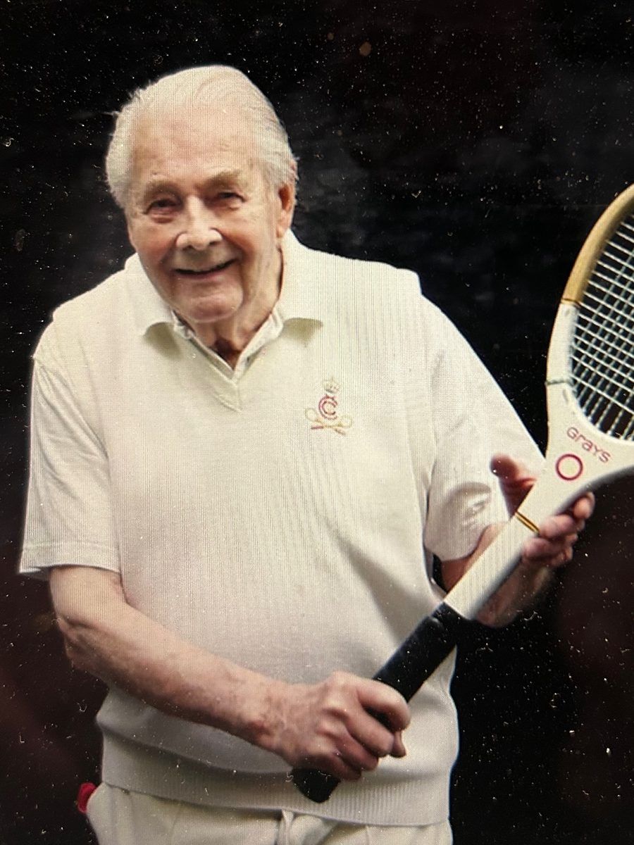 Master Robin Simpson holding a real tennis racquet